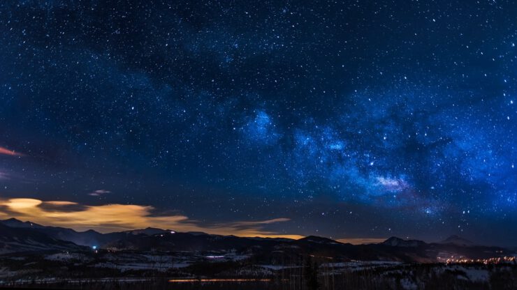 black mountains under the stars at nighttime