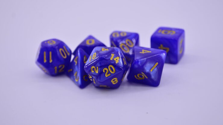 purple dices with different geometrical shape on a white surface