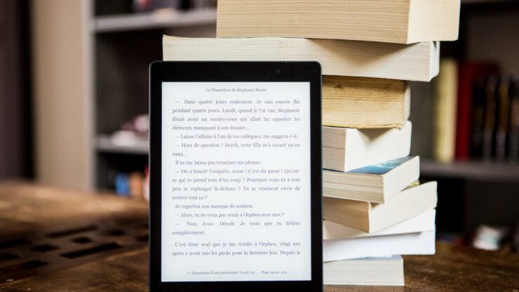 black tablet computer behind books